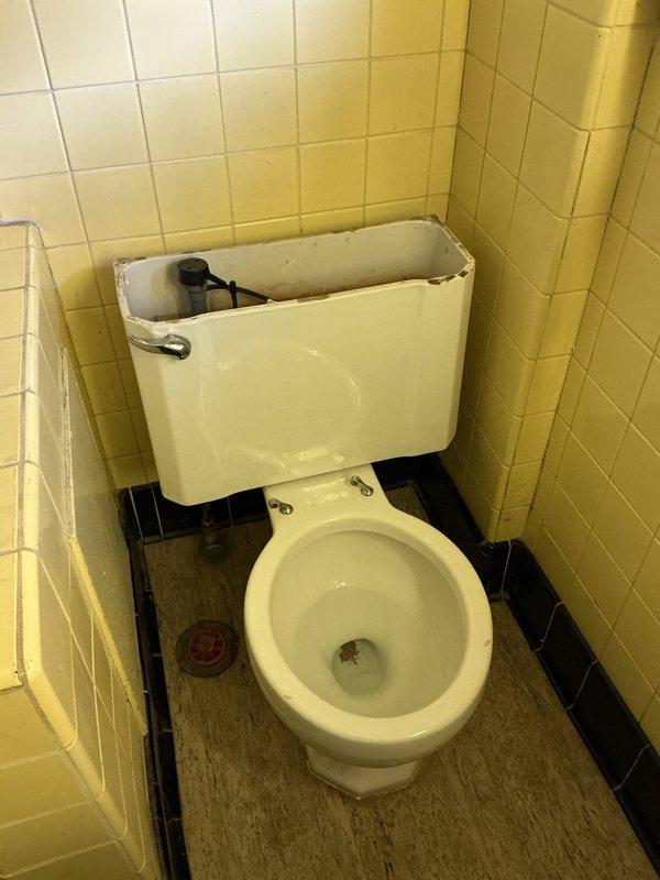 Responded to a toilet repair requiring complete tank overhaul and floor reconnection. Upon arrival, found toilet improperly secured to floor flange and tank components heavily corroded with mineral deposits and rust buildup. Removed toilet in two pieces due to tight workspace constraints in corner installation. Replaced all internal tank components including flush valve, fill valve, flapper assembly, and supply line connections. Cleaned extensive mineral deposits from tank interior. Reset toilet bowl to floor flange with new wax ring and closet bolts, ensuring proper seal and stability. Reconnected tank to bowl with new tank-to-bowl gasket and hardware. Tested flush mechanism and verified no leaks at all connection points.