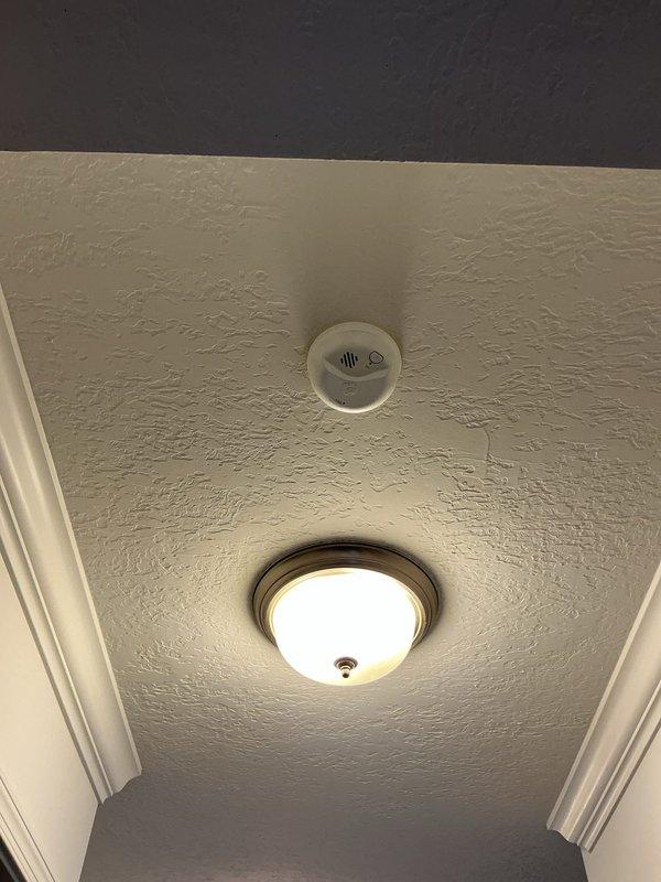 Replaced eight end-of-life smoke detectors throughout residential property with new 10-year sealed battery units. Installed combination smoke/carbon monoxide detectors on each floor level and individual smoke detectors in all bedroom locations. Blanked off one redundant detector location on the second floor where two units were positioned adjacent to each other.