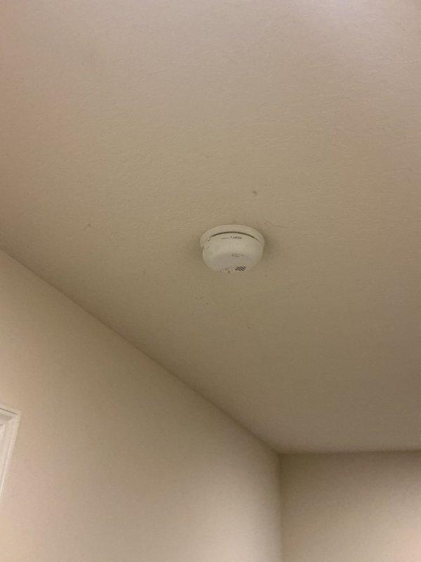 Replaced eight end-of-life smoke detectors throughout residential property with new 10-year sealed battery units. Installed combination smoke/carbon monoxide detectors on each floor level and individual smoke detectors in all bedroom locations. Blanked off one redundant detector location on the second floor where two units were positioned adjacent to each other.