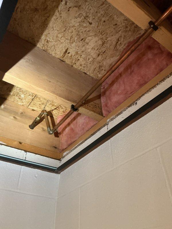 Serviced two 30-year-old frost-free hose bibs that were soldered to copper piping. Performed repacking and installed new washers on both units to restore proper function and eliminate leaks. Accessed one hose bib with standard clearance while the second required maneuvering around existing plumbing infrastructure in a confined space near ceiling joists with exposed insulation. Both fixtures are now operating correctly with no drips or water seepage.
