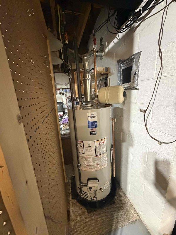 # HVAC Install - Complete System

Completed installation of a 90-gallon residential hot water heater in basement utility area. Unit was positioned against concrete block wall on stable concrete floor pad with proper clearances maintained per manufacturer specifications. Connected all supply and discharge plumbing using copper pipe with appropriate fittings and isolation valves for future serviceability. Installed electrical connections in accordance with local electrical codes and manufacturer requirements, routing wiring through overhead joists to main electrical panel.

Performed commissioning procedures including system pressure testing and verification of proper operation. Utilized UEi EM720 digital manometer to measure and verify gas pressure at the gas valve, confirming readings within acceptable range for safe and efficient operation. Checked all plumbing connections for leaks and verified proper venting configuration. Tested temperature and pressure relief valve for proper oper
