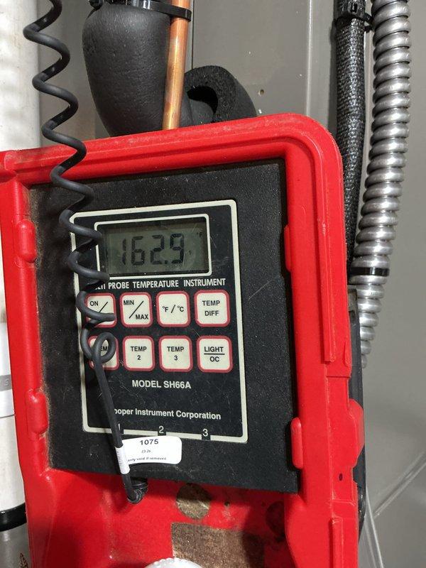 Completed full HVAC system installation including outdoor Lennox condensing unit mounted on concrete pad with proper drainage and rock landscaping. Installed refrigerant lines, electrical disconnect, conduit, and all necessary connections to exterior wall with secure mounting brackets. Verified system performance with temperature differential readings showing 162.9°F, confirming proper operation and heat exchange efficiency.