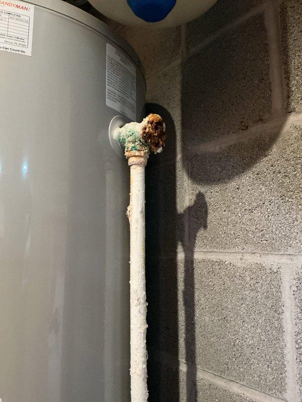 Provided quote for replacement of 50-gallon gas water heater with regular vent configuration in tall form factor. Upon inspection, found severe corrosion on top of existing unit, particularly at the copper pipe connections and tank outlet fittings, with visible green copper oxidation and brown rust deposits indicating advanced deterioration. The existing HANDYMAN-branded water heater showed significant age-related wear with corroded brass fittings and compromised piping connections at the tank top. Documented existing installation including galvanized vent piping, copper supply lines, pressure relief valve assembly, and expansion tank configuration for accurate replacement specifications.