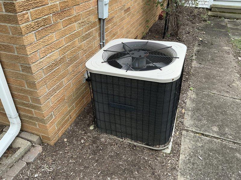 Provided comprehensive estimate for replacement of 18-year-old residential air conditioning system experiencing refrigerant leak and low charge. Evaluated existing outdoor condenser unit positioned on concrete pad against exterior brick wall, assessed property specifications including 1,200 square foot main level, 900 square foot basement, and insulated attic space. Presented equipment options and financing solutions for air conditioning replacement to address aging system and refrigerant loss issues.