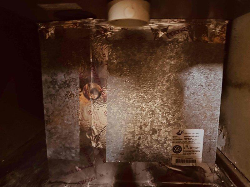 Responded to service call for 15-year-old furnace displaying pressure switch stuck open error code. Upon inspection, discovered extensive frost and ice crystallization throughout the unit's interior, covering the heat exchanger and evaporator coil surfaces. Diagnosed airflow restriction issue causing improper system operation and pressure switch failure. Cleared ice buildup, inspected heat exchanger for cracks, verified proper venting, and tested pressure switch operation. Unit returned to normal operating condition with proper airflow restored.