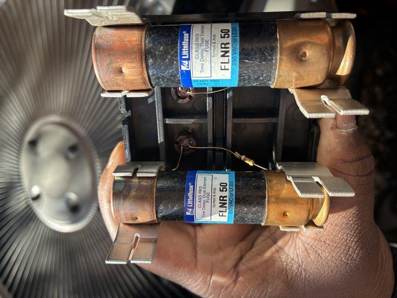 Completed annual precision tune-up on one-year-old furnace and air conditioning system. Performed comprehensive inspection of outdoor condensing unit, verified electrical connections and amperage readings using clamp meter, inspected and tested FLNR 50 amp fuses in disconnect box, checked refrigerant pressures, cleaned condenser coil, and evaluated overall system performance. All components found operating within manufacturer specifications with no issues identified during routine maintenance visit.