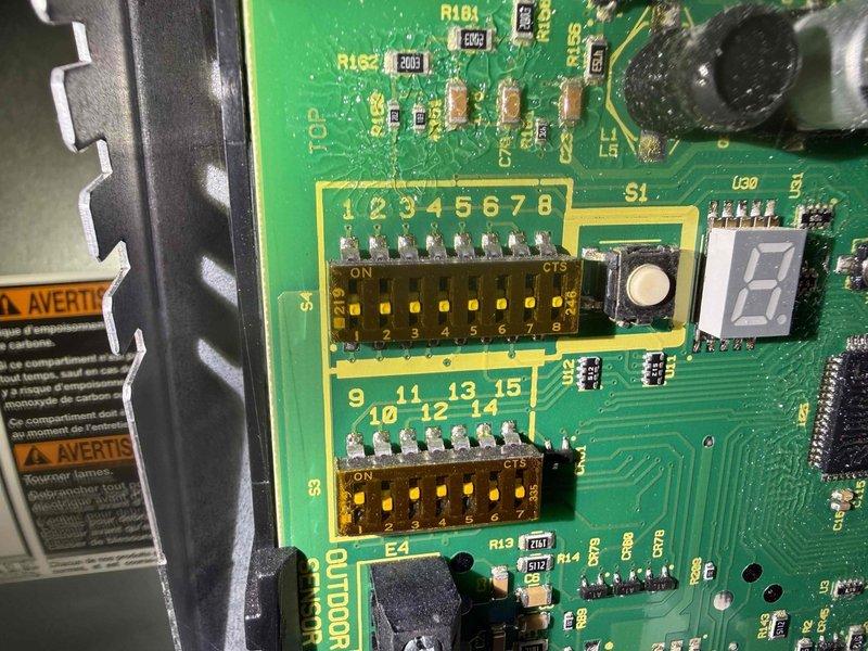 Completed comprehensive furnace maintenance inspection and system evaluation. Removed access panel to examine internal components, including blower assembly, control board, and electrical connections. Inspected green circuit board PCB with all electronic components, DIP switches, and LED display module showing proper configuration and functionality. Verified wire harnesses, connections, and routing throughout unit were secure with appropriate wire management. Noted accumulated dust and debris on blower compartment filter area. Examined drain pan, interior cabinet condition, and all manufacturer safety labels. All electrical components, including integrated circuits, resistors, and control system connections, found to be in proper working order with no signs of damage or wear.