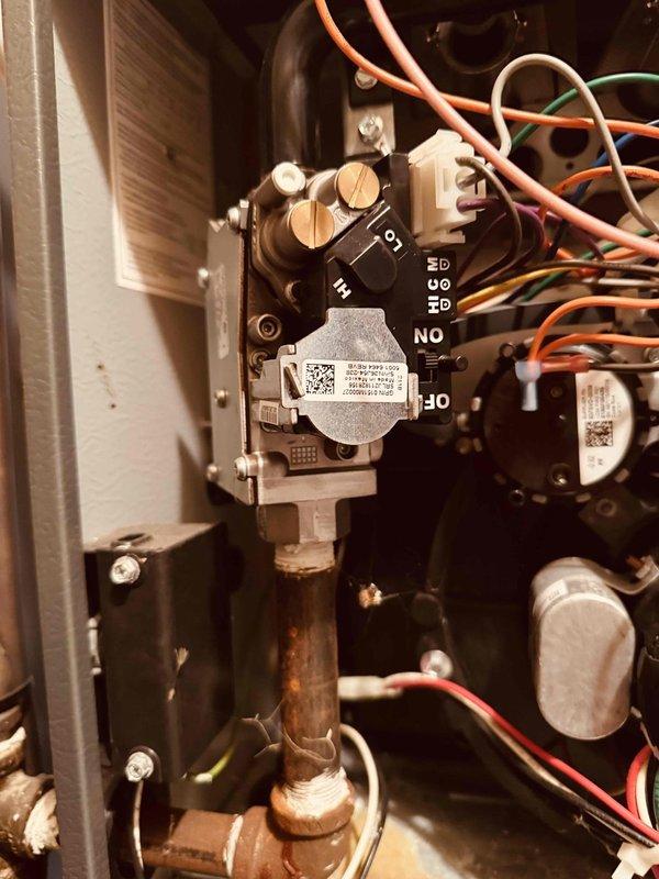 Responded to gas leak emergency on 5-year-old furnace where Columbia Gas had already shut down system for safety. Performed diagnostic testing using digital manometer to measure gas pressure at valve assembly, confirming burner bleeding issue. Inspected gas valve, control wiring connections, and copper supply line for potential failure points. Documented equipment condition with photos showing gas valve assembly, pressure readings, and wire connections to terminals. Furnace remains offline pending further repairs to address gas valve or control box malfunction causing the leak condition.