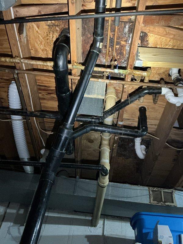 Responded to service call for tanked water heater with pilot light failure. Upon arrival, inspected water heater unit located in basement utility area and assessed the condition of the appliance and surrounding plumbing infrastructure. The water heater exhibited symptoms consistent with thermocouple malfunction or gas valve issues preventing the pilot light from remaining lit. Documented existing conditions including overhead drainage system with black PVC piping, water supply lines, and mechanical room configuration. Evaluated the water heater's operational components, connections, and safety systems to determine the cause of pilot light failure and provided assessment for necessary repairs or replacement considerations.