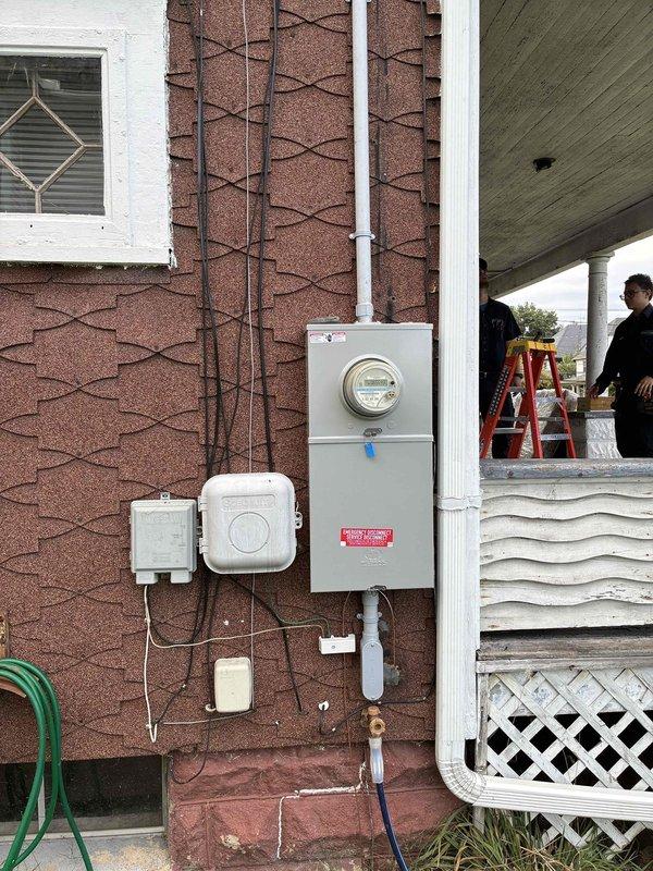 Responded to callback for damage assessment and repair related to previous installation work. Upon arrival, inspected electrical service equipment at exterior meter location and documented existing installation condition. Investigated reported issue with refrigerator circuit and structural joist that was inadvertently damaged during prior electrical installation. Assessed interior wall outlet location and surrounding area where damage occurred. Documented both exterior service panel configuration and interior affected area with photographs for records and potential repair coordination.