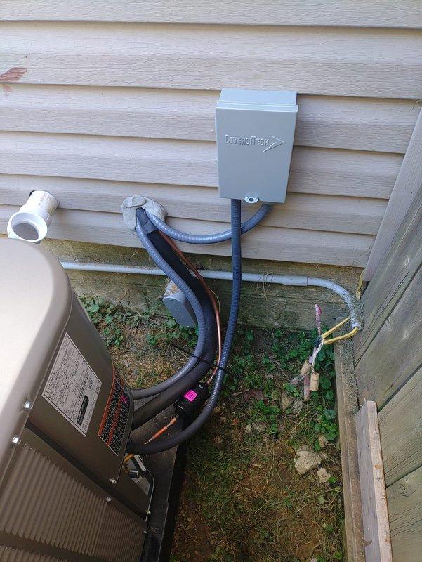 Completed full HVAC system installation including outdoor condensing unit mounted on composite pad with proper clearances from building and fence line. Installed DiversiTech electrical disconnect box, ran and insulated refrigerant line set with black foam insulation, and completed all electrical connections and conduit work per code requirements. System tested and operational.