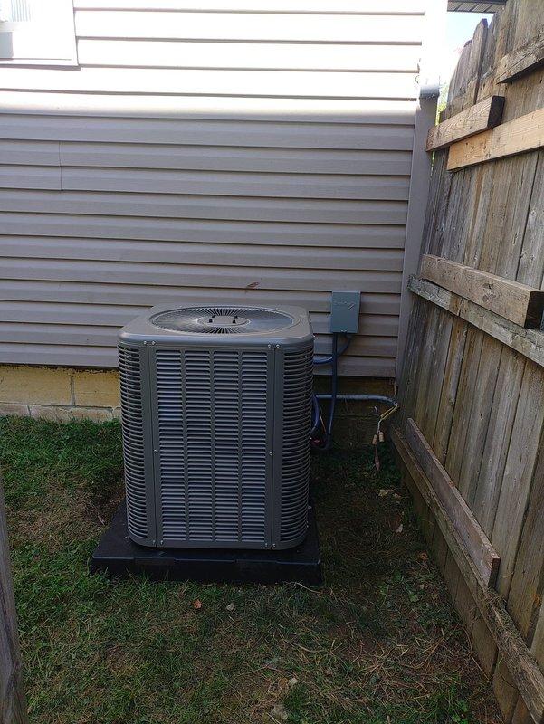 Completed full HVAC system installation including outdoor condensing unit mounted on composite pad with proper clearances from building and fence line. Installed DiversiTech electrical disconnect box, ran and insulated refrigerant line set with black foam insulation, and completed all electrical connections and conduit work per code requirements. System tested and operational.
