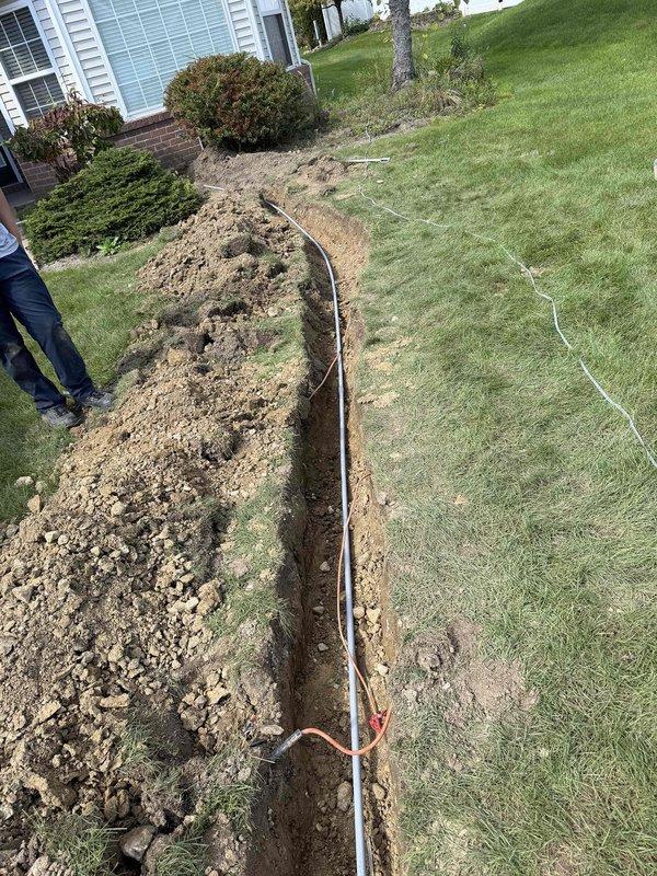 Retrenched power supply to front yard post light by excavating and installing PVC conduit along the existing pathway from the front office outlet to the light fixture, providing enhanced protection and durability for the underground electrical run. Replaced an overheating air conditioning circuit breaker in the main electrical panel to restore safe operation and prevent potential fire hazards.