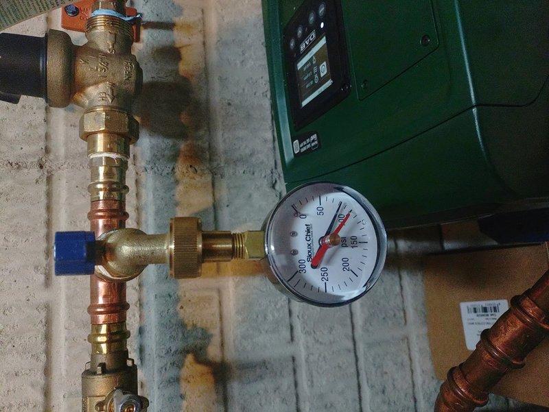 Responded to low water pressure complaint regarding DAB Esybox mini booster pump installed approximately three months prior. Customer reported inadequate performance affecting in-ground sprinkler system operation. Upon arrival, conducted visual inspection of exterior booster pump installation and associated PVC piping configuration. Verified mounting hardware and backflow preventer assembly condition. Checked system pressure gauge readings and evaluated pump performance parameters. Inspected brass fittings, compression connections, and valve assemblies for proper operation. Assessed pump control settings and pressure switch calibration. Documented current system configuration with photographs showing exterior wall-mounted installation and pressure gauge assembly. Verified electrical connections and pump cycling operation. System evaluation completed to determine cause of reduced water pressure and diminished sprinkler performance compared to initial installation standards.