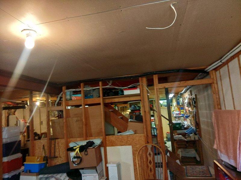Installed fifth indoor head unit in basement area of existing mini-split system. Recovered refrigerant from system, added new lineset for additional zone, and recharged system with precise refrigerant weight calculated for expanded configuration including all five head units. Installation completed in unfinished basement space with new head unit mounted and connected to existing outdoor condenser unit.