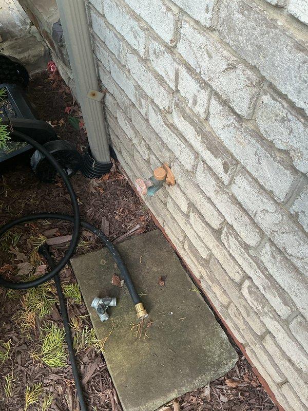 Completed repair of leaking outdoor hose bib that was spraying water at the exterior wall penetration. Accessed interior crawl space to replace failed valve assembly and secure copper supply line. Tested system under full pressure to confirm leak elimination and proper operation of the outdoor spigot.