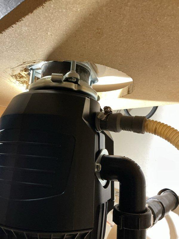 Replaced failed InSinkErator Badger 5 garbage disposal that was leaking from the bottom seal. Removed existing unit from sink mounting assembly and disconnected hardwired electrical connection. Installed new 3/4 horsepower disposal unit with quiet technology, reconnected to existing sink drain flange, and rewired electrical using hardwired configuration. Verified proper P-trap alignment, tested unit operation and drainage, and confirmed no leaks at mounting points or drain connections.