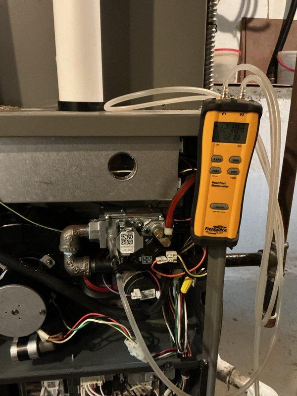 Completed comprehensive MVP heating maintenance on residential furnace system. Performed thorough inspection of all internal components including motor assembly, capacitor, wiring harnesses, and control board connections. Utilized dual port manometer to measure and verify gas pressure at 298 units, ensuring proper combustion and system efficiency. All electrical connections, terminal blocks, and wire bundles were inspected and found to be secure and properly organized. Gas valve assembly, piping connections, and safety controls were examined and confirmed to be operating within manufacturer specifications. System tested and verified to be functioning safely and efficiently for the heating season.