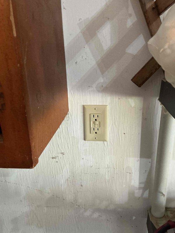 Responded to service call for non-functioning garage GFCI outlet and inoperative basement recessed lighting. Troubleshot garage outlet circuit after previous GFI and breaker reset attempts proved unsuccessful; diagnosed wiring fault and restored power to GFCI receptacle. Investigated basement lighting issue where two of three can lights on single switch remained non-operational despite bulb replacement; identified potential cam mechanism failure or circuit wiring defect requiring further investigation.