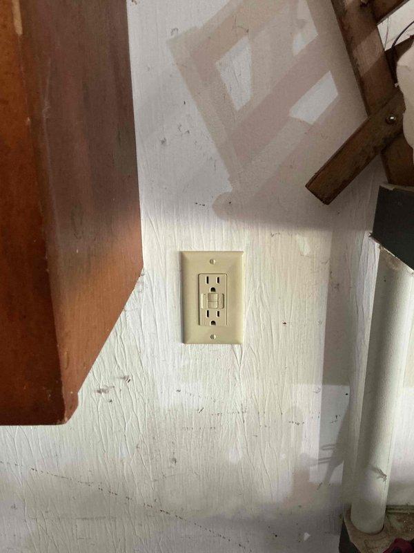 Responded to service call for non-functioning garage GFCI outlet and inoperative basement recessed lighting. Troubleshot garage outlet circuit after previous GFI and breaker reset attempts proved unsuccessful; diagnosed wiring fault and restored power to GFCI receptacle. Investigated basement lighting issue where two of three can lights on single switch remained non-operational despite bulb replacement; identified potential cam mechanism failure or circuit wiring defect requiring further investigation.