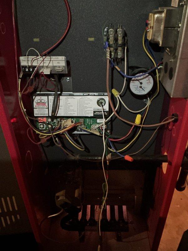 Completed annual maintenance on 10-year-old hydronic boiler system. Performed visual inspection of electrical components, control board, contactors, and pressure controls within cabinet; all components functioning within normal parameters. Inspected expansion tank, circulator connections, and associated copper piping; noted minor rust staining on valve assembly but no active leaks detected. System tested and operating properly.