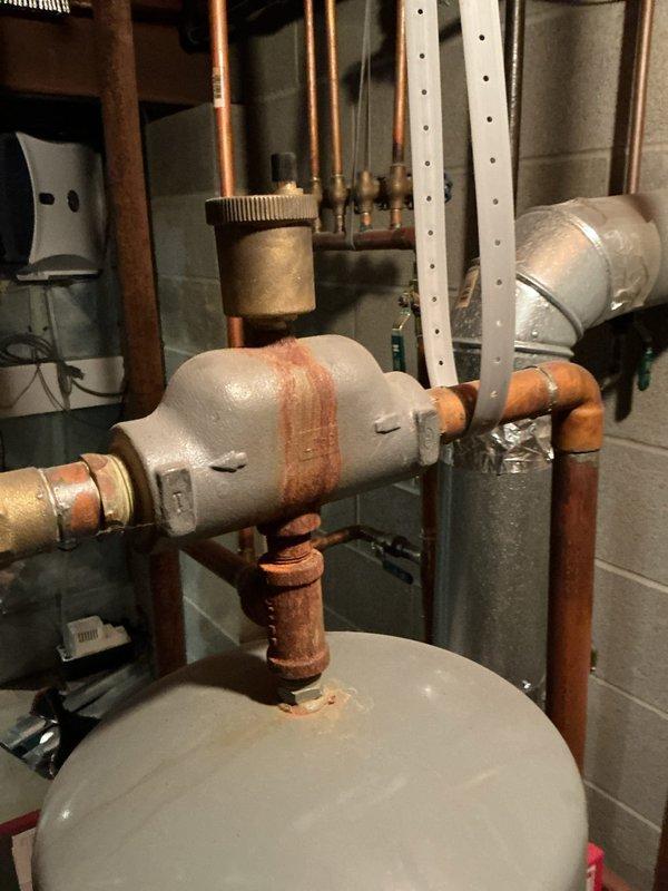 Completed annual maintenance on 10-year-old hydronic boiler system. Performed visual inspection of electrical components, control board, contactors, and pressure controls within cabinet; all components functioning within normal parameters. Inspected expansion tank, circulator connections, and associated copper piping; noted minor rust staining on valve assembly but no active leaks detected. System tested and operating properly.