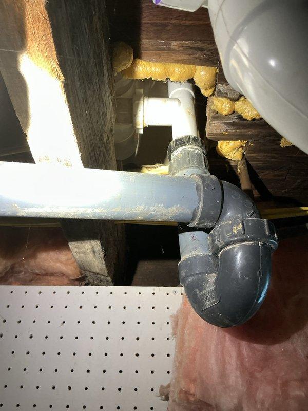 Responded to service call for bathtub not holding water when plugged. Inspected tub drain assembly from access point below fixture and identified faulty drain stopper mechanism preventing proper seal. Accessed underfloor plumbing through crawlspace, verified P-trap and drainage lines were clear and functioning properly. Documented existing three-handle tub valve configuration and drain assembly condition with photos for customer review and approval of recommended repairs.