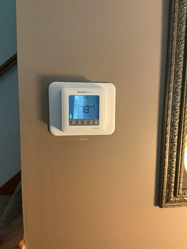 Completed warranty installation of Honeywell Home digital thermostat at residential location. Replacement unit was previously ordered and received at shop prior to service call. Removed defective thermostat, installed new unit on existing wall plate, verified proper wiring connections, and confirmed system operation with accurate temperature display and control functionality.