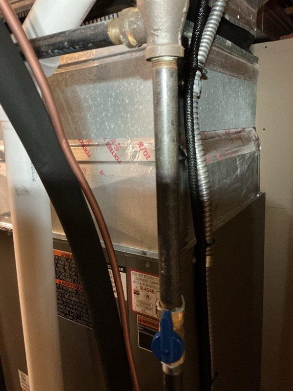 Completed installation of a 90% AFUE furnace and air conditioning system. Installed new furnace unit with copper refrigerant lines, gas piping with blue handle shut-off valve, and flexible metallic conduit for electrical connections. Connected evaporator coil assembly with proper insulation and ductwork transitions. Verified system operation with digital temperature instrumentation showing 15.3-degree temperature differential, confirming proper heat exchange and airflow performance across the complete HVAC system.