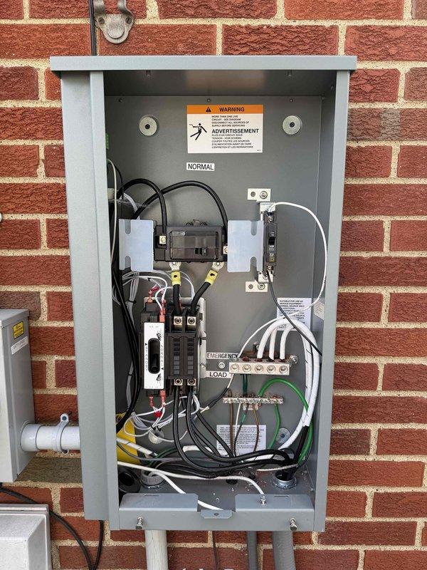 Relocated standby generator unit requiring specialized generator van and equipment for 5-hour installation process. Measured and verified proper clearances from building structure and established new mounting location on concrete pad. Ran ethernet cable from main electrical panel to generator control system for remote monitoring capabilities using specialized installation tools. Installed and configured automatic transfer switch with proper load center connections, ensuring seamless transition between utility and emergency power sources. Verified all electrical connections within transfer switch panel including main breaker, branch circuit breakers, and proper wire management of black, white, yellow, and green conductors. Tested emergency and normal operation modes to confirm proper functionality of the complete generator system.