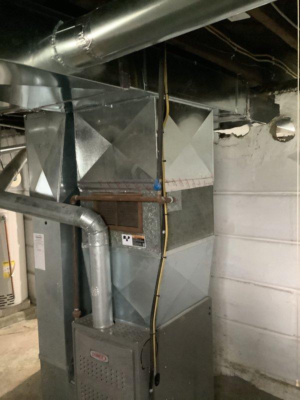 Disconnected existing spider duct configuration and installed new trunk line to accommodate reconfiguration across block wall partition. Completed duct runs on opposite side of wall, cutting and fitting remaining branch lines to ensure proper airflow distribution throughout the system. All ductwork properly sealed and secured to Lennox furnace unit with galvanized steel trunk and flex duct connections verified for optimal HVAC performance.