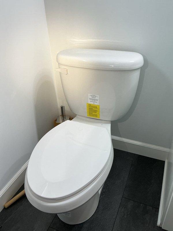 Responded to service call for leaking toilet. Upon inspection, identified faulty flapper seal within the flush valve assembly causing continuous water seepage into the bowl. Removed tank lid, replaced defective blue flapper component with new seal, and tested flush mechanism for proper operation. Verified leak was resolved and all internal tank components functioning correctly with no further water loss detected.