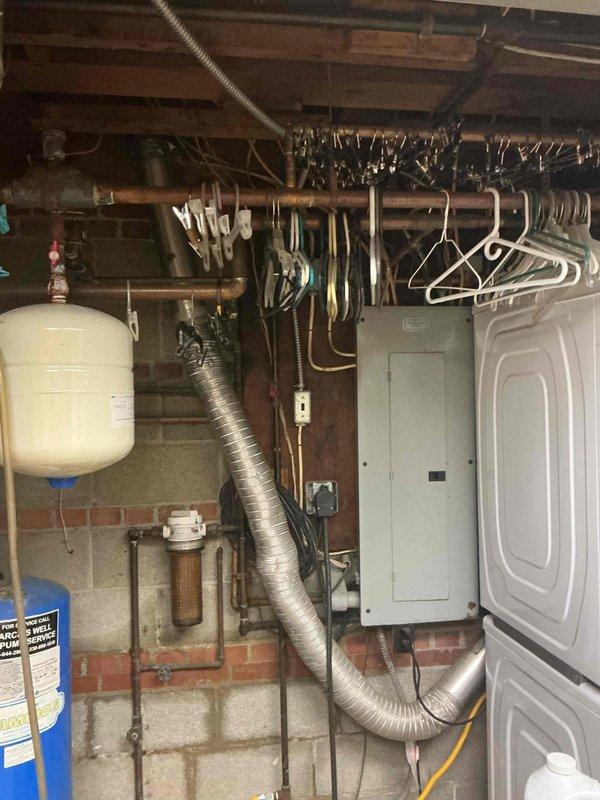 Completed electrical estimate for standby generator installation at residential property. Assessed exterior installation location on side of building, noting significant vegetation overgrowth that will require clearance to meet code requirements for generator placement and adequate ventilation. Evaluated existing electrical service in basement utility area, documenting current main electrical panel location and capacity. Photographed existing plumbing, ductwork, and mechanical systems to plan electrical routing from panel to exterior generator pad location. Provided customer with comprehensive estimate including equipment options and installation scope. Recommended vegetation removal and site preparation prior to installation to ensure proper clearances and accessibility for maintenance.