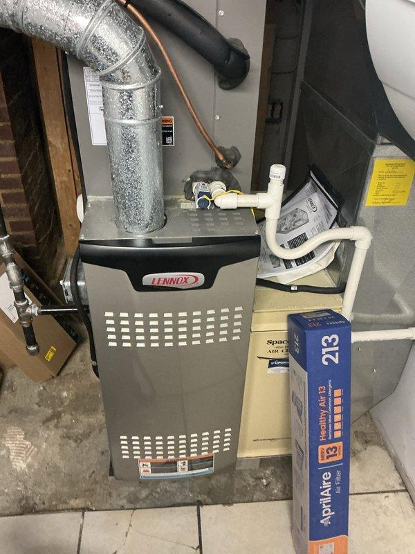 Completed MVP air conditioning maintenance on residential cooling system. Performed comprehensive inspection of outdoor condensing unit, accessing electrical panel to examine capacitor, contactor, and associated wiring connections. All electrical components showed normal wear with secure wire terminations. Inspected indoor Lennox furnace and air handler system in basement, noting proper operation of blower assembly and ventilation components. Observed heavy condensation on metallic supply ductwork, indicating system is cooling effectively. Verified refrigerant lines, condensate drainage system, and PVC drain lines for proper function. System operating within normal parameters with no immediate service needs identified.