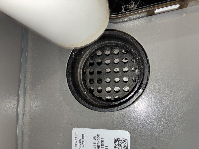Completed comprehensive MVP furnace maintenance including inspection of heat exchanger fins, which showed dust accumulation and cobweb material between metallic fins indicating need for cleaning. Verified drain pan and condensate system functionality, noting proper moisture drainage through perforated grate assembly and confirming condensate line positioning.