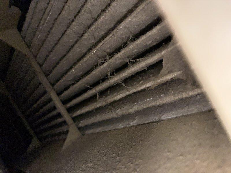 Completed comprehensive MVP furnace maintenance including inspection of heat exchanger fins, which showed dust accumulation and cobweb material between metallic fins indicating need for cleaning. Verified drain pan and condensate system functionality, noting proper moisture drainage through perforated grate assembly and confirming condensate line positioning.