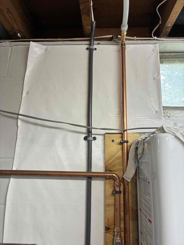 Installed dedicated electrical circuit for tankless water heater system. Ran new wiring from main electrical panel through basement utility area to tankless unit location, securing conductors properly along floor joists and through insulated crawl space. Installed appropriate circuit breaker in main service panel and completed all electrical connections per manufacturer specifications and local electrical code requirements for tankless water heater installation.