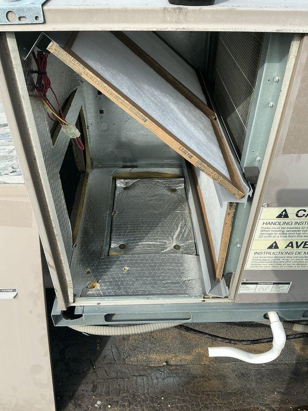 Responded to no cooling complaint on rooftop-mounted commercial HVAC unit. Upon arrival, accessed unit through top panel and inspected internal components including air handler, ductwork, and electrical connections. Unit appeared to be in serviceable condition with proper insulation and wiring intact. Verified unit operation and completed visual inspection of exterior casing, mounting platform, and drainage lines on gravel roof surface.