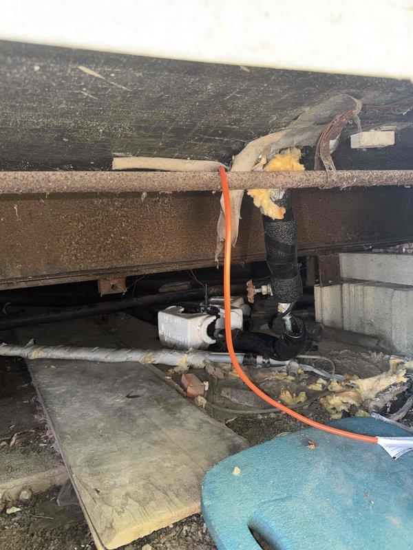 Installed approximately 30 feet of heat tape beneath mobile home to protect main water supply line from freezing. Heat tape was routed along water line path through crawl space and connected to existing electrical outlet near home entry point. Installation completed to ensure freeze protection for incoming water service during cold weather conditions.