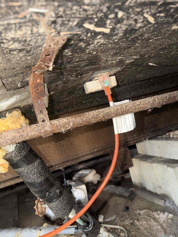 Installed approximately 30 feet of heat tape beneath mobile home to protect main water supply line from freezing. Heat tape was routed along water line path through crawl space and connected to existing electrical outlet near home entry point. Installation completed to ensure freeze protection for incoming water service during cold weather conditions.