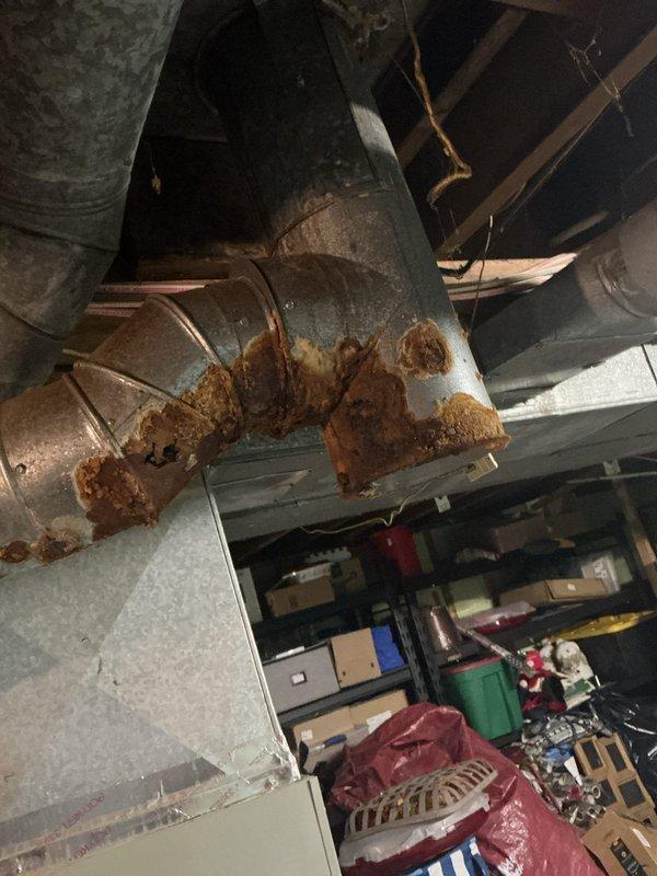 Responded to no-heat call for 14-year-old fuel oil furnace located in basement. Upon arrival, performed comprehensive system diagnostic and visual inspection of furnace components and exhaust venting system. Confirmed significant rust and corrosion on exhaust vent pipes leading to chimney, consistent with customer's initial report. Documented extensive deterioration of metal ductwork, including corroded elbow joint with flaking material and compromised structural integrity. Assessed that exhaust vent pipe replacement is necessary for safe operation and code compliance. Photographed corroded ductwork and equipment for customer records and future reference. Provided customer with detailed findings regarding furnace start failure and exhaust system deterioration requiring immediate attention to restore safe heating operation.