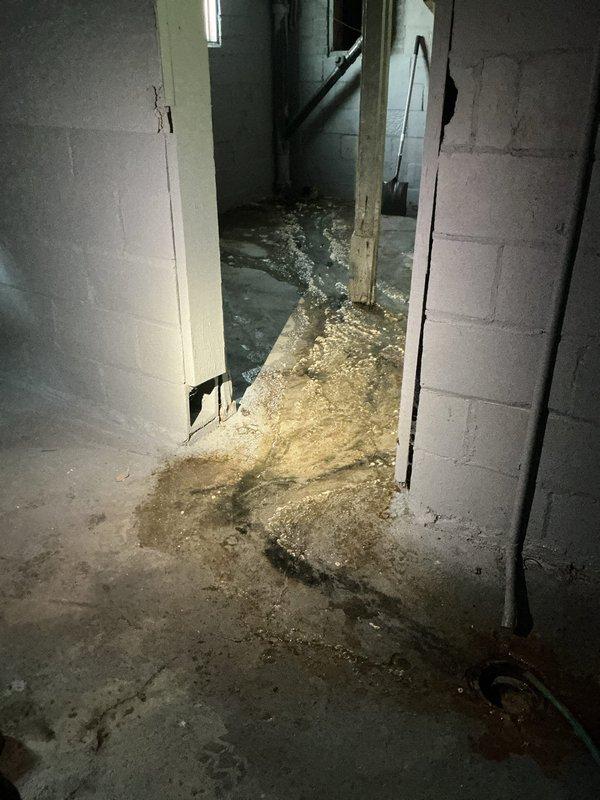 Responded to basement flooding caused by failed sewer stack fitting beneath concrete floor. Jackhammered basement floor around the sewer stack to access the compromised fitting at the concrete penetration point. Removed damaged fitting and installed new connection, tying back into the existing ABS drain line above the concrete. Completed concrete excavation, pipe replacement, and reconnection to restore proper drainage and prevent further water intrusion.