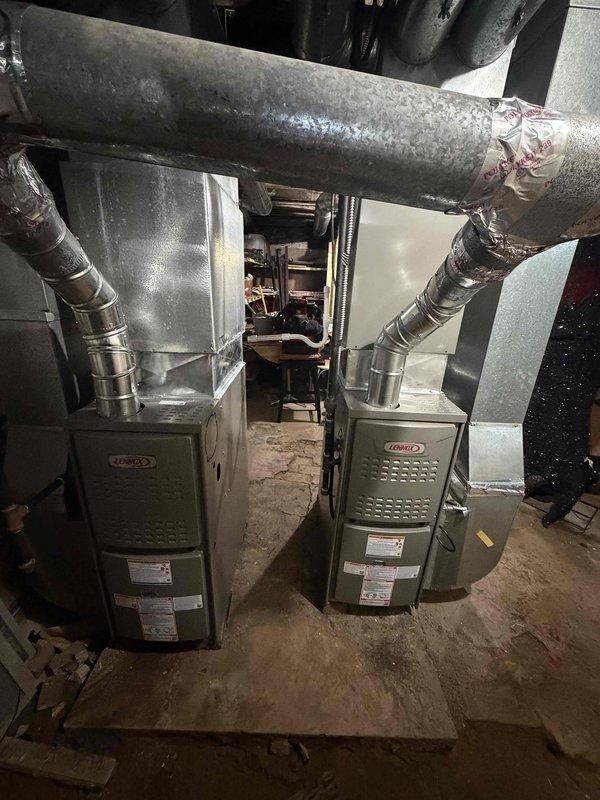 # HVAC Install - Furnace

Successfully completed the installation of two 80% efficiency Lennox furnaces in residential basement mechanical room. Both units were installed side by side with proper clearances and connected to existing ductwork system. Configured supply and return air pathways using insulated flexible ductwork and metal plenums. All electrical connections were completed per manufacturer specifications and local code requirements. Units were mounted on concrete floor with appropriate leveling and secured in compliance with installation standards. Ductwork connections were sealed and insulated to prevent air leakage and ensure optimal system efficiency. Both furnace units were tested for proper operation, airflow, and safety controls. System startup procedures were performed on each unit to verify proper ignition sequence, flame sensing, and blower operation. Installation included proper labeling and documentation affixed to equipment as required by code.