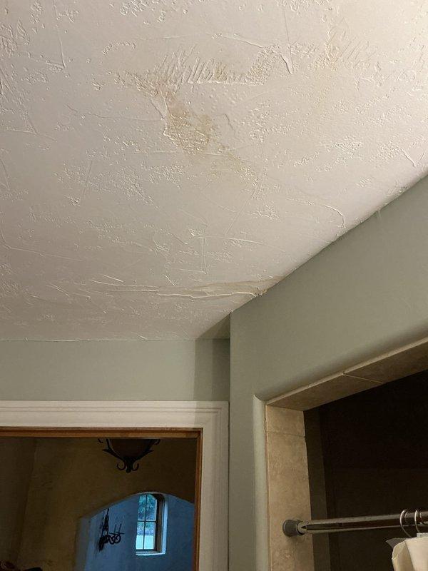Responded to water leak complaint affecting two areas: basement ceiling and main floor. Performed diagnostic inspection and accessed wall cavity to locate source of leak. Identified compromised copper plumbing lines running through wall structure between floors. Removed section of drywall to expose framing, insulation, and copper piping for proper assessment and repair access. Secured copper pipes with appropriate mounting brackets and addressed leak points. Documented conditions with photos showing ceiling texture damage, exposed wall framing with fiberglass insulation, and copper pipe routing through stud cavities.