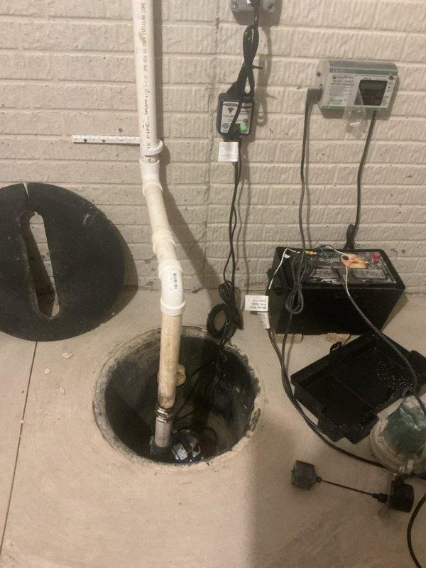Installed battery backup sump pump system to complement existing one-year-old primary pump. System includes backup pump unit, battery power supply with monitoring capabilities, and properly configured discharge piping integrated with existing PVC discharge line. All electrical connections completed, monitoring panel mounted and programmed, and system tested to ensure automatic activation during primary pump failure or power outage scenarios.