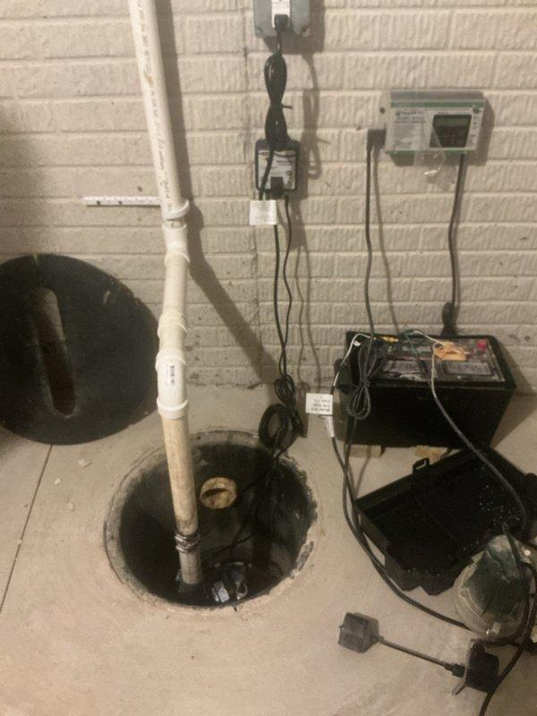 Installed battery backup sump pump system to complement existing one-year-old primary pump. System includes backup pump unit, battery power supply with monitoring capabilities, and properly configured discharge piping integrated with existing PVC discharge line. All electrical connections completed, monitoring panel mounted and programmed, and system tested to ensure automatic activation during primary pump failure or power outage scenarios.