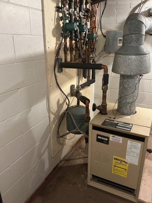 Performed scheduled boiler inspection at commercial facility. Conducted comprehensive visual examination of heating system including boiler unit, copper piping network, circulation pumps, and associated plumbing components. Verified proper operation of green-bodied circulator pumps, inspected condition of copper supply and return lines for signs of corrosion or leaks, and assessed overall system integrity. Confirmed all mechanical connections, valves, and electrical components were functioning within normal parameters. No service calls required at this time. System found to be operating satisfactorily with routine wear consistent with age of equipment.