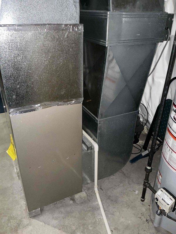 Conducted comprehensive HVAC system evaluation for furnace and air conditioning replacement estimate. Assessed existing equipment configuration including current air handler unit with insulated ductwork, existing duct system infrastructure, and surrounding utility space constraints. Documented equipment layout, ductwork connections, electrical components, and available clearances to determine optimal replacement specifications and installation requirements for new heating and cooling system.