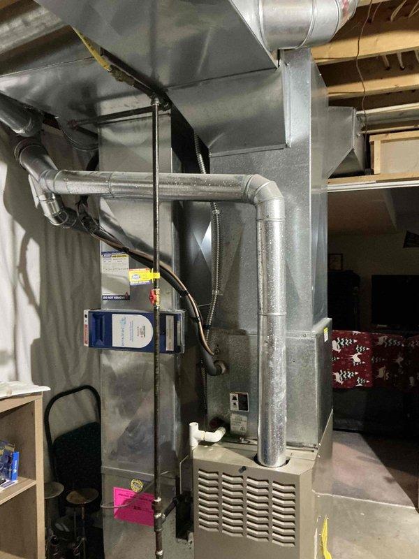 Conducted comprehensive HVAC system evaluation for furnace and air conditioning replacement estimate. Assessed existing equipment configuration including current air handler unit with insulated ductwork, existing duct system infrastructure, and surrounding utility space constraints. Documented equipment layout, ductwork connections, electrical components, and available clearances to determine optimal replacement specifications and installation requirements for new heating and cooling system.