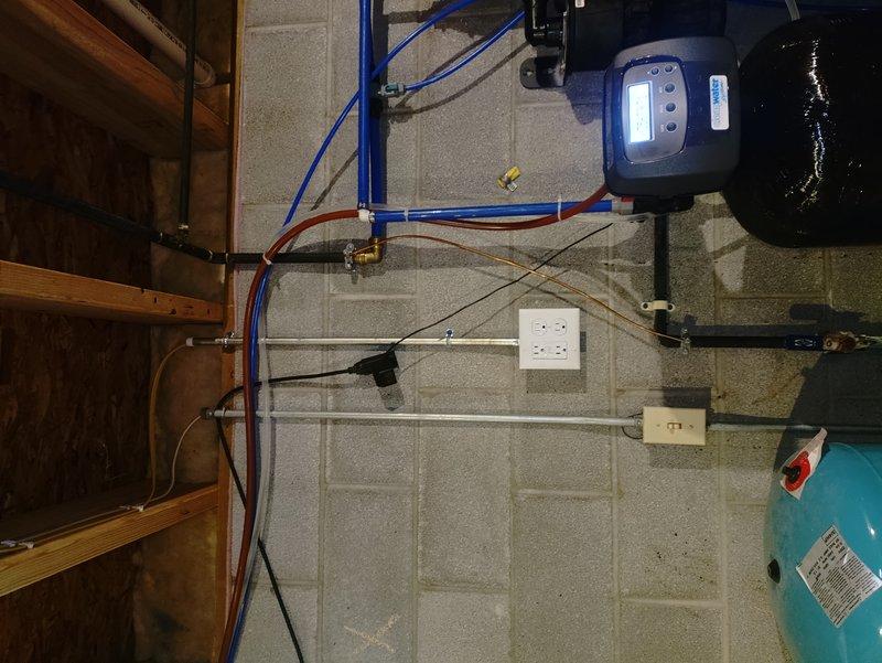 Replaced existing can light fixture above back bedroom shower with new 6" LED wafer light, removing old bracket as needed for proper installation. Installed new dedicated 20-amp circuit from main electrical panel to water softener location, terminating in properly grounded outlet to eliminate unsafe extension cord usage and provide code-compliant power supply for equipment.